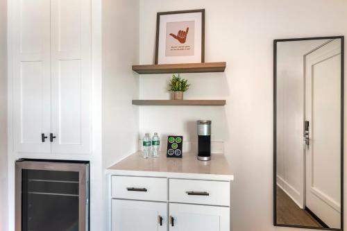 a kitchen with white cabinets and a mirror at Ocean Surf at York Beach in York