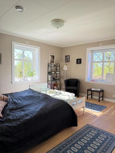 a bedroom with a bed and a living room at Naturskönt boende nära sjö in Ör