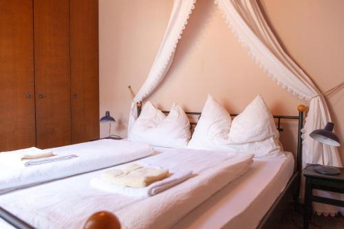 a bedroom with two beds with white sheets and pillows at Atriumhof in Rust