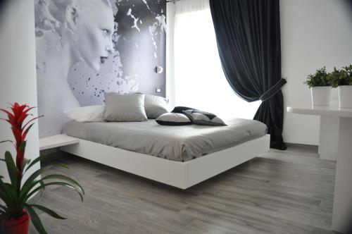 a bedroom with a bed with a large window at Caos Calmo in Rome