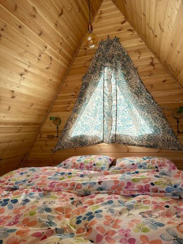 a bedroom with a bed and a window in a room at Mountain Stories Kazbegi-Stepantsminda in Kazbegi