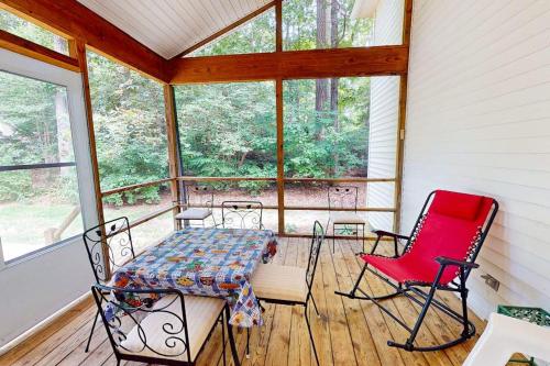 a screened in porch with a table and chairs at 37 Moonraker Road in Ocean Pines