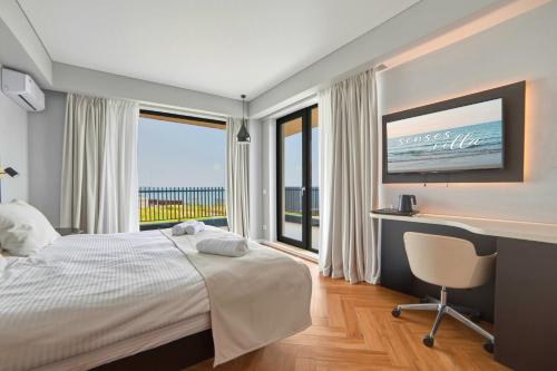 a bedroom with a bed and a desk and a window at Senses Villa By PopDan in Vama Veche