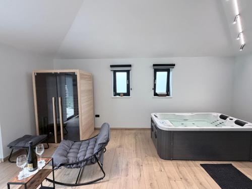 a room with a hot tub and a table and chairs at House Avena with spa & gym in Labin