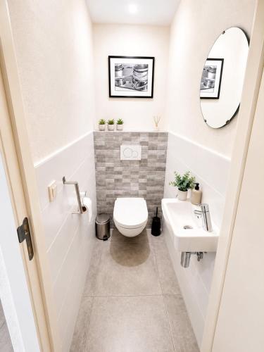 a bathroom with a toilet and a sink at L'Appart de Grand-Père in Oudenburg