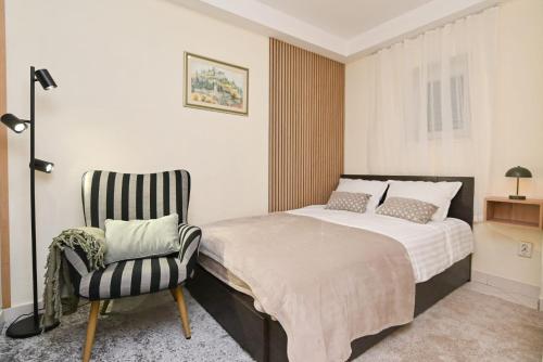 a bedroom with a bed and a chair at Brko's Place Sinj in Sinj