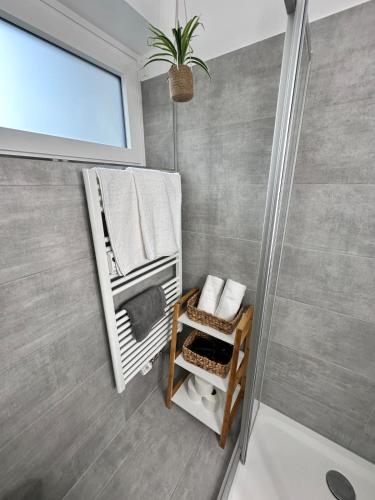 a bathroom with a towel rack and a shower at Grimming Lodge Tauplitz II in Tauplitz