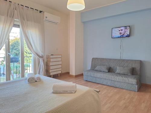 a bedroom with a bed and a couch at Medoro Piazza Roma Rooms in Milazzo