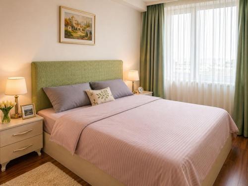 a bedroom with a large bed and a window at Bishkek Park Apartments in Bishkek