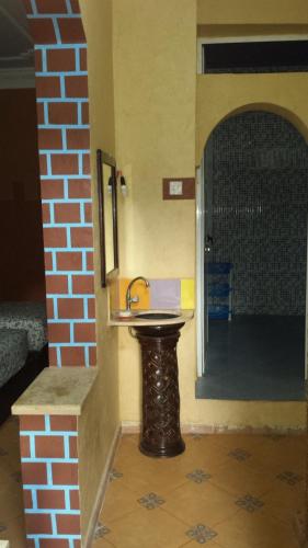 a bathroom with a sink in the corner of a room at Taddart Aglou in Zaouit Aglou