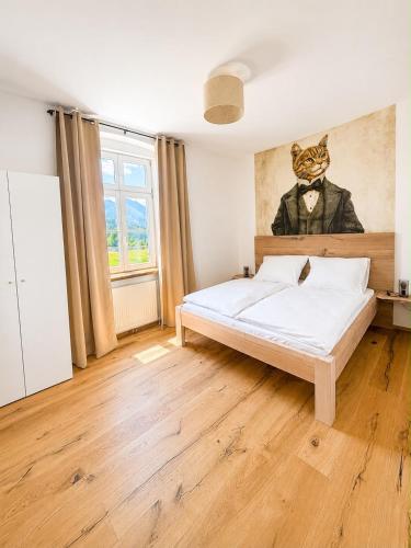 a bedroom with a bed with a cat in a suit at Casa Roberto, Apartment 2 in Mariazell