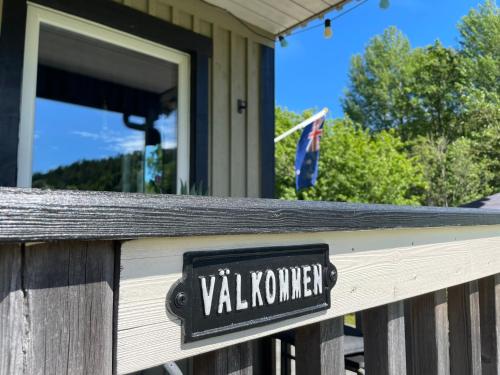 a sign on the front of a wooden fence at Haere Mai B&B Orust in Henån