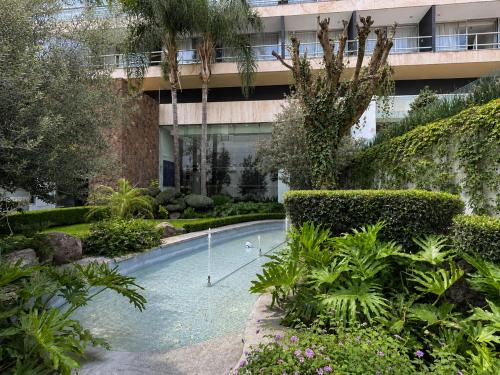 a swimming pool in front of a building at Panorama in San Luis Potosí