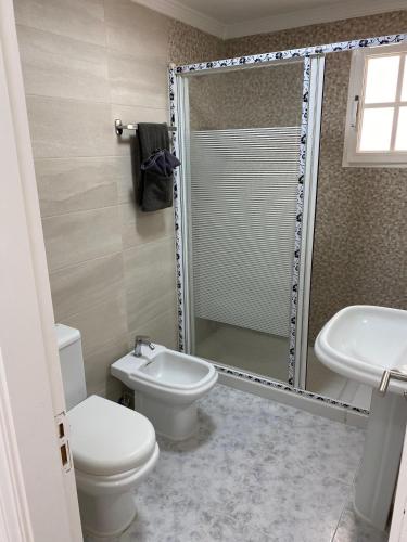 a bathroom with a toilet and a sink and a shower at Cura Marina in Playa del Cura