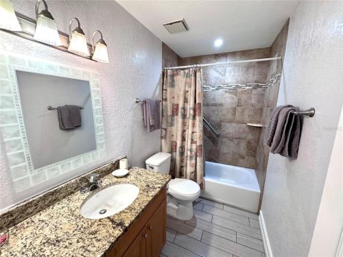 a bathroom with a sink and a toilet and a shower at 1+1 Large condo Sarasota in Sarasota