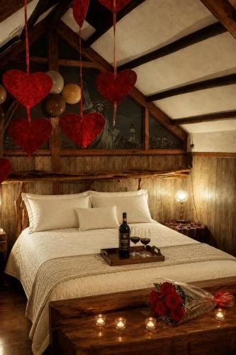 a bedroom with a bed with red hearts on the wall at Cabaña en La Calera con Jacuzzi in La Calera
