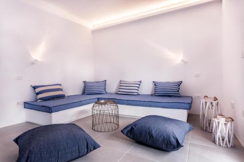 a room with a blue bench with pillows on it at Flag Suites in Pollonia