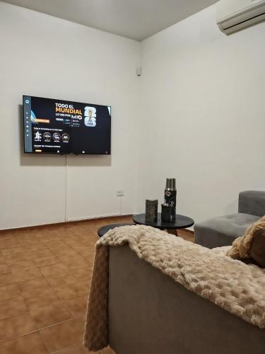 a living room with a couch and a flat screen tv at Casa amplia 3 dormitorios, 2 baños - Smart TV 50" - Entrada Autónoma - Pileta de Verano in Mendoza