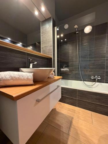 a bathroom with a sink and a shower at Apartment Essreithweg Kaprun by Jara in Kaprun