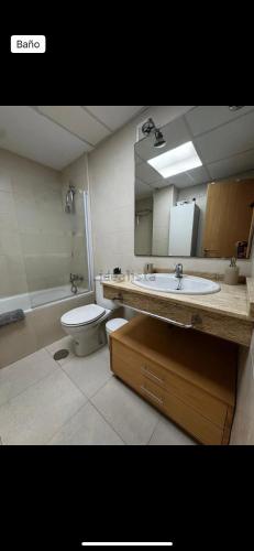 a bathroom with a sink and a toilet and a mirror at Vera dream Las Marinas LAGUNA BEACH in Vera