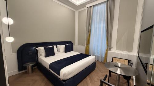 a bedroom with a bed and a television in it at Palazzo Montella in Naples