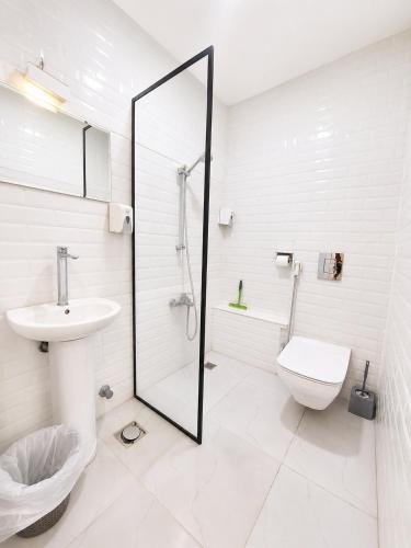 a white bathroom with a toilet and a sink at Velvet city view in Cairo