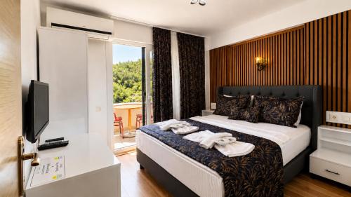 a bedroom with a bed with towels on it at Olive Branch Hotel in Ayvalık