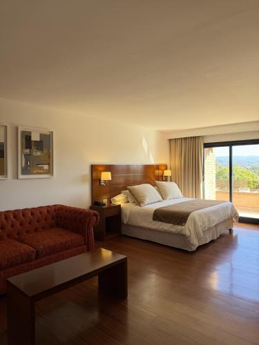 a bedroom with a bed and a couch at Neper Hotel in Córdoba