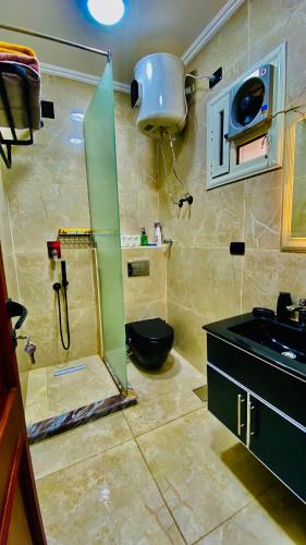 a bathroom with a shower and a toilet and a sink at Emerald flat in Marsa Alam City