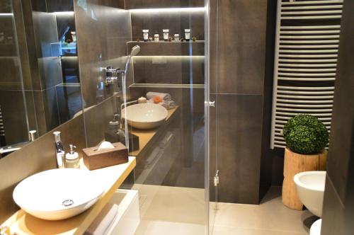 ザコパネにあるAtelier Zakopane Apartamenty pod Giewontemのバスルーム(洗面台、ガラス張りのシャワー付)