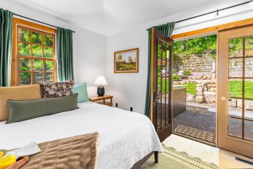 a bedroom with a bed and a door to a yard at Harvest and Hearth in Galena