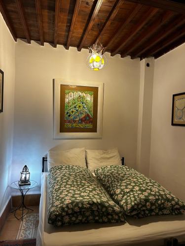 a bedroom with a bed and a chandelier at Riad Dar Afram in Essaouira