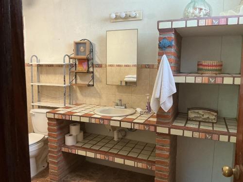 a bathroom with a sink and a toilet at Brisa Suave Studio Suite in Punta Mita