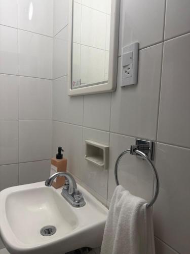 a bathroom with a sink and a mirror and a towel at casa granada en Carranza in San Luis Potosí