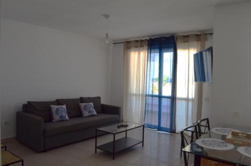 a living room with a couch and a table at Montaña Tirba in Costa Calma