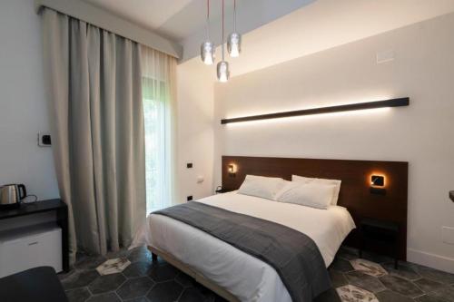 a bedroom with a large bed and a large window at Ca'santoro 3 in Agerola