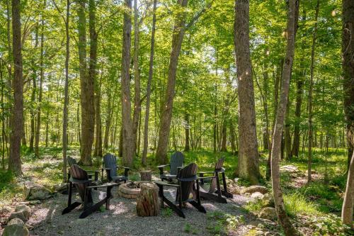 a group of tables and chairs in the woods at Peace at Last by Railey Vacations in McHenry