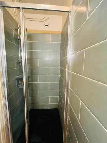 a shower with a glass door in a bathroom at Studio Cosy - Le Grand-Bornand in Le Grand-Bornand