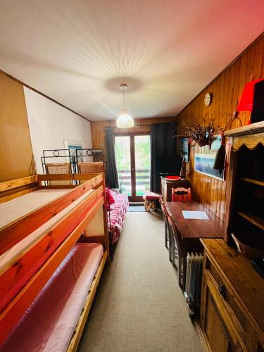 a bedroom with two bunk beds and a desk at Studio Cosy - Le Grand-Bornand in Le Grand-Bornand