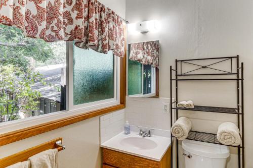 a bathroom with a toilet and a sink and a window at Quiet Patio! La Cañada Month-Long Studio in La Canada Flintridge