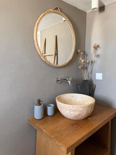 a bathroom with a sink and a mirror at Villa Olympia with private pool in Antiparos