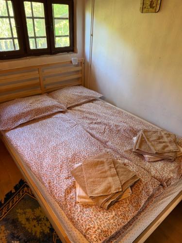 a bed in a room with towels on it at Rokova Dolina in Draganovac