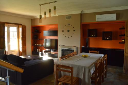 a living room with a table and a fireplace at Cantinho do Minho - Ponte de Lima in Ponte de Lima