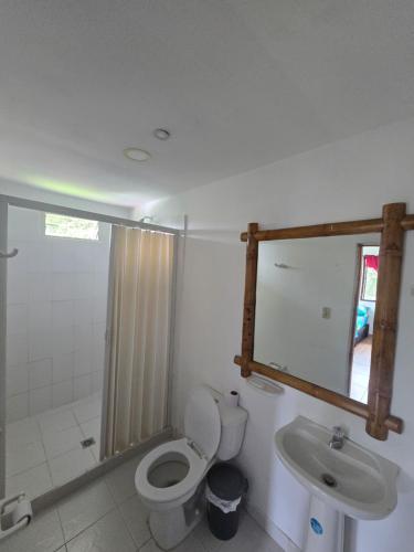 a bathroom with a toilet and a sink at Finca hotel los cocos in Montenegro