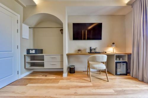 a living room with a table and a chair at Las Torres by Santas Hotels in Altea