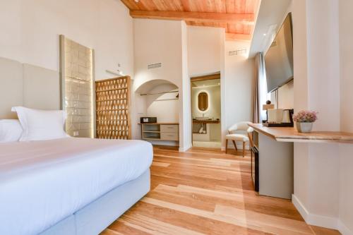 a bedroom with a white bed and a desk at Las Torres by Santas Hotels in Altea