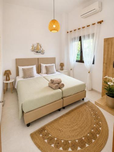 a bedroom with two beds and a rug at Gennadi Sea Escape in Gennadi