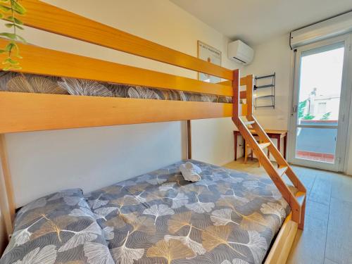 a bedroom with a bunk bed with a ladder at Casa Lido in Lido Adriano