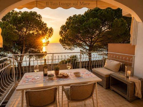 a table and chairs on a balcony with a view of the ocean at BeachfrontGrado Seaview Apartment Costa Azzurra in Grado