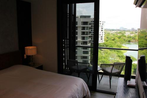 a hotel room with a bed and a large window at Panoramic Lake View Cabo Norte Mérida in Mérida